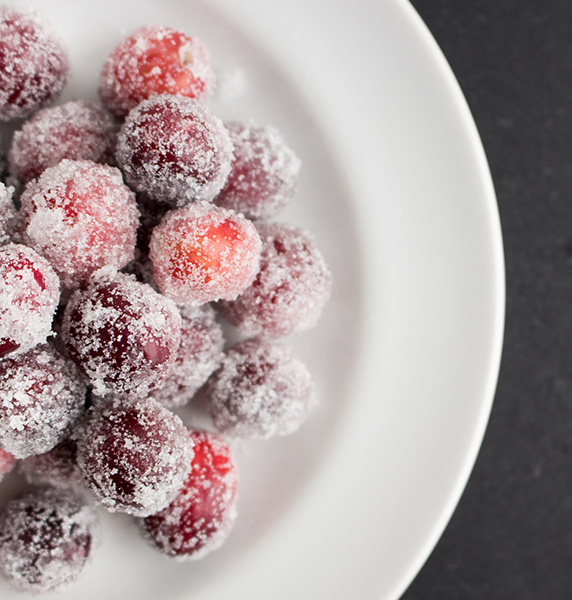 whole fresh cranberries rolled in sugar piled on a white plate