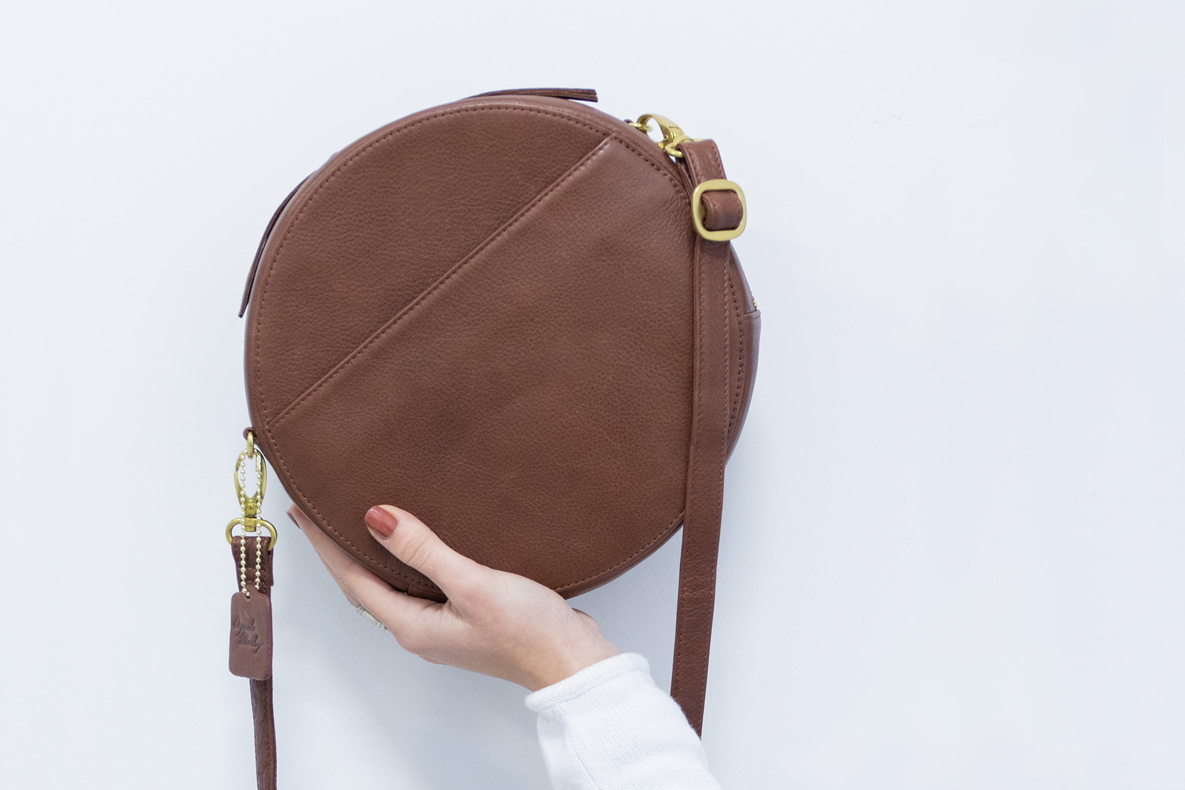 hand holding circular bag